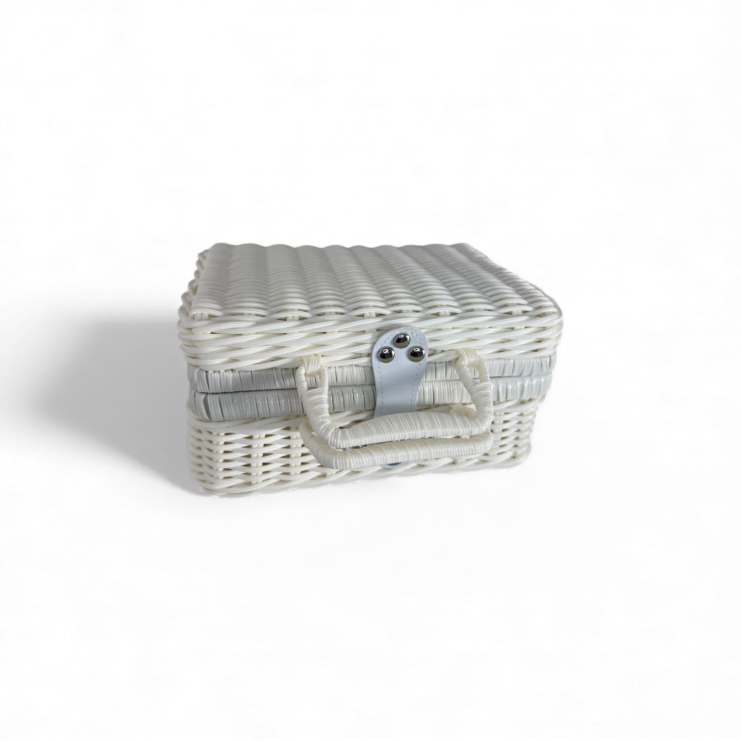 Closed white wicker baby keepsake suitcase with handle and latch, displayed on a clean white background