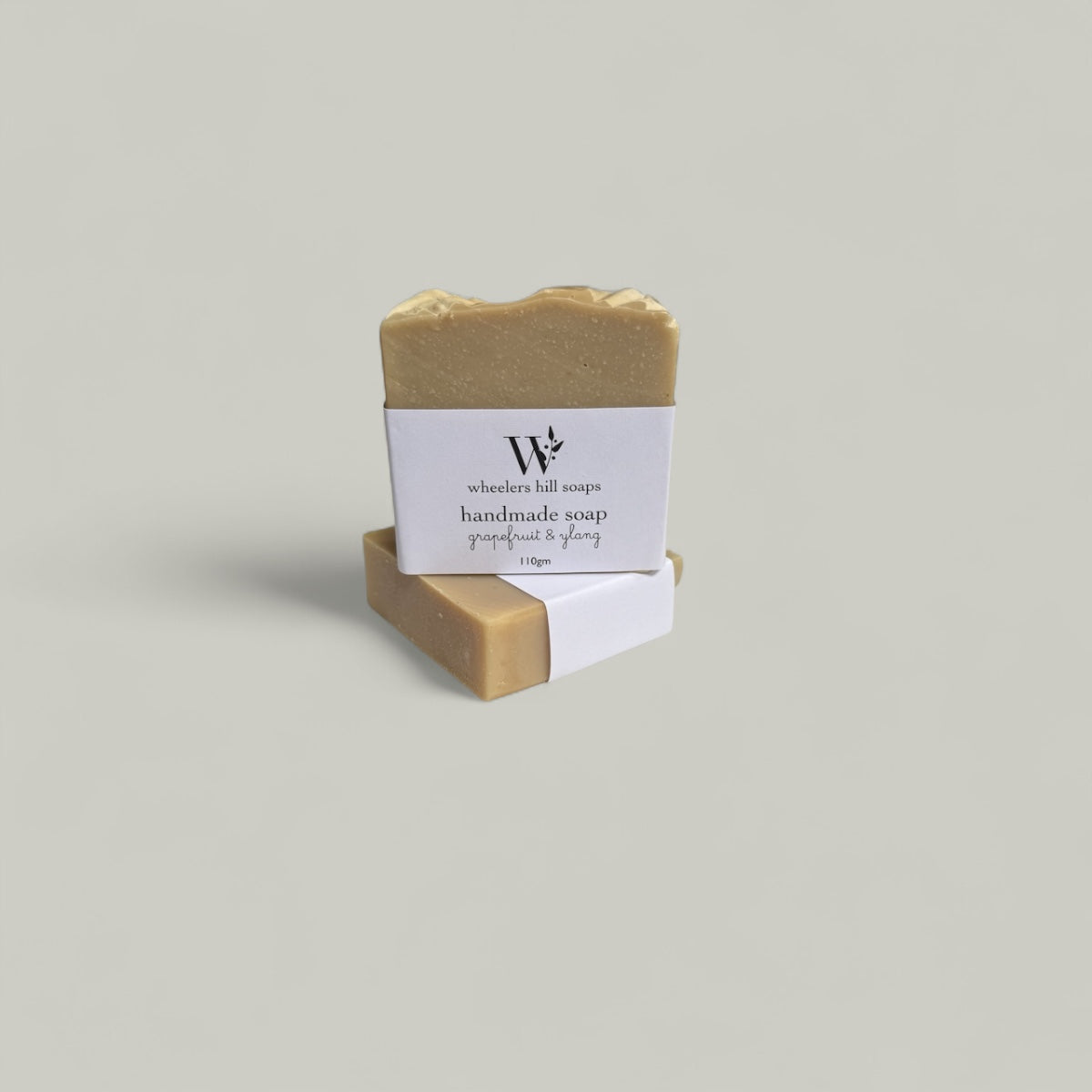 Handmade soap bar in grapefruit and ylang scent in a light background