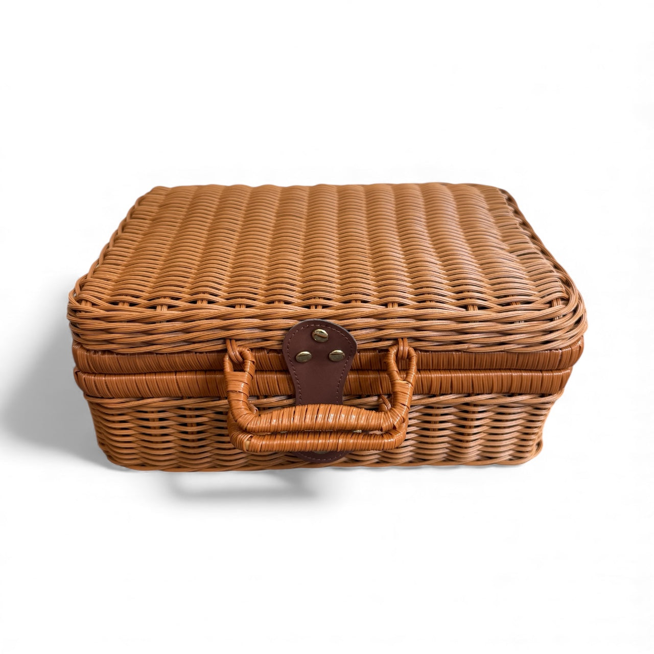 Wicker baby hamper suitcase closed, shown on a white background
