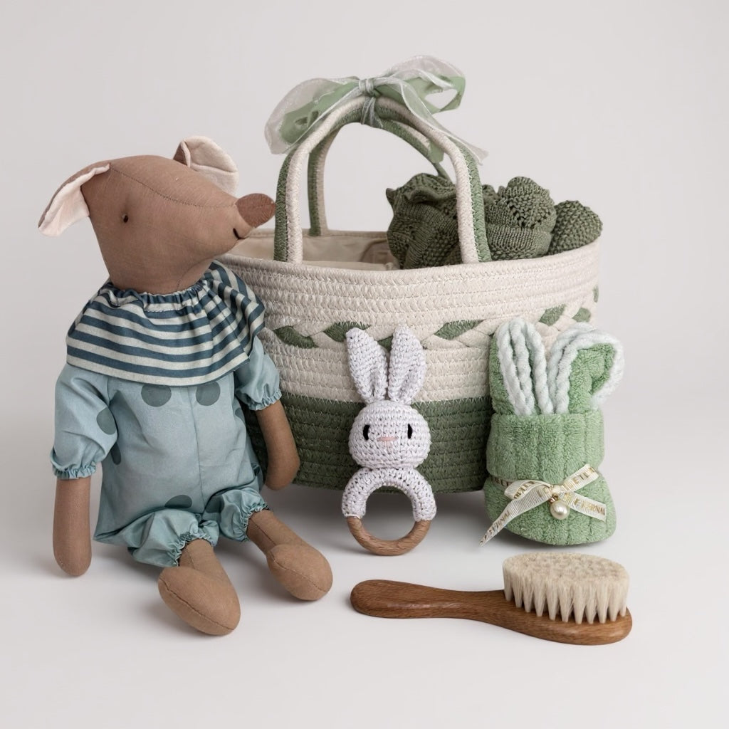 Children's toy set with a plush animal, basket, and baby care items on a light background