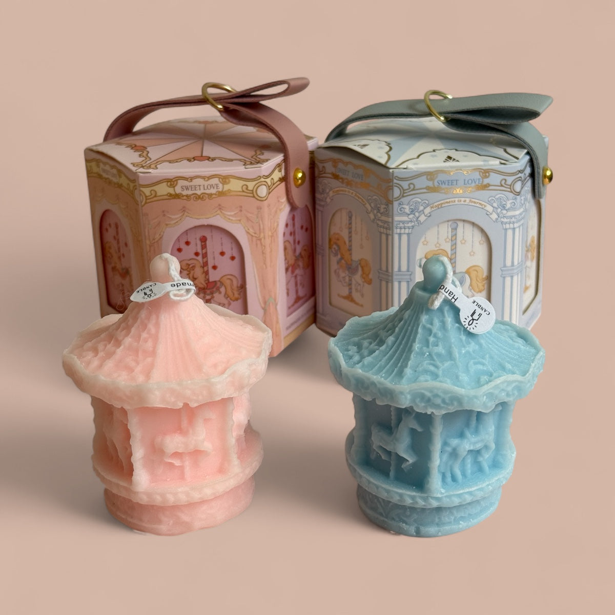 Pink and blue carousel candles with decorative gift boxes
