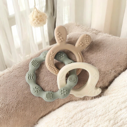 Texture silicone teether trio in soft beige and sage, BPA- free baby toy for soothing gums