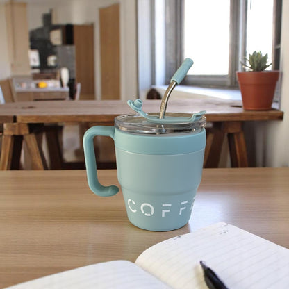 Light blue mug with 'COFFE' text on a wooden table in a room setting.