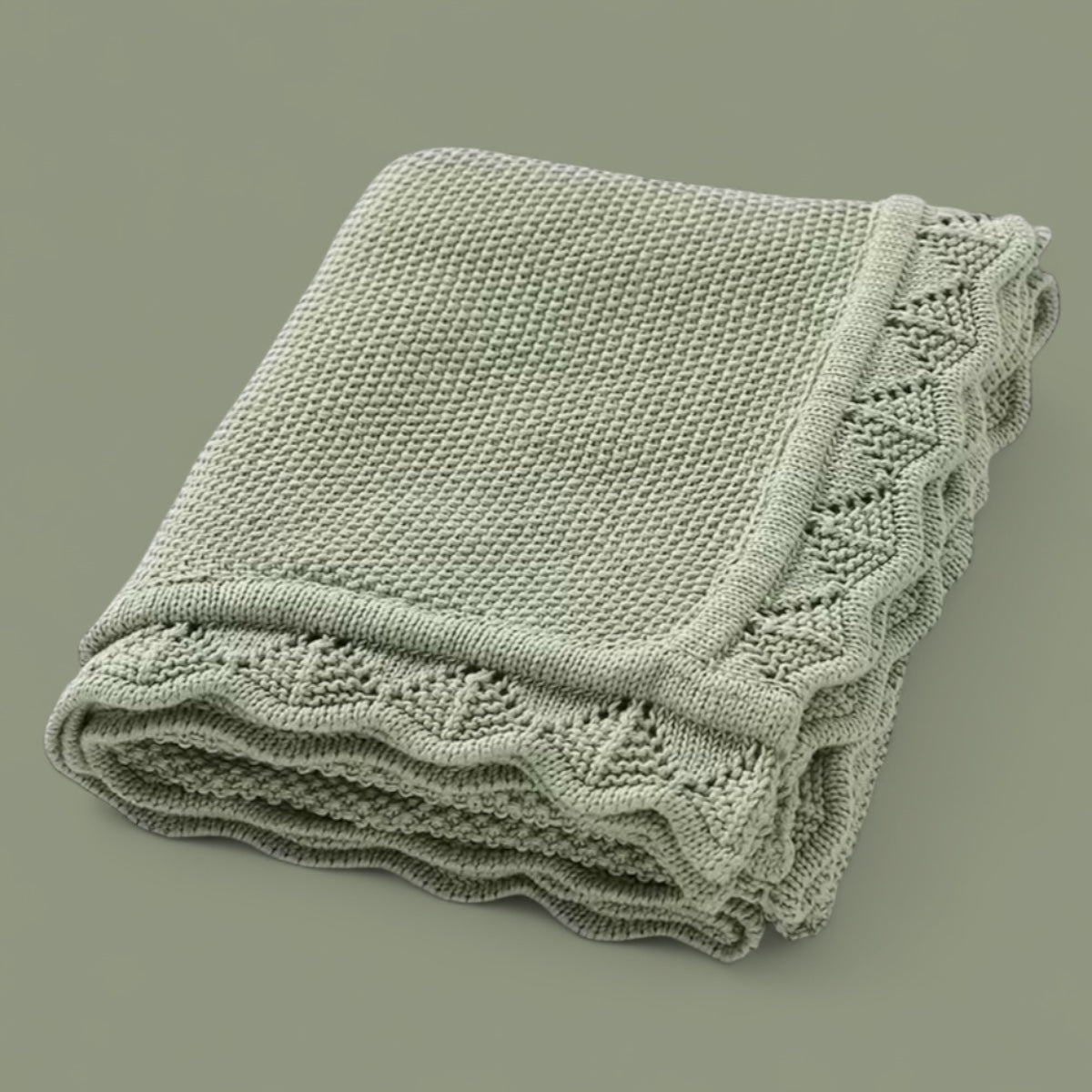 Soft knitted baby blanket with subtle openwork texture, folded neatly