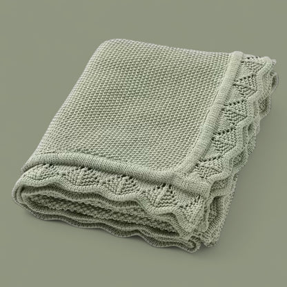 Soft knitted baby blanket with subtle openwork texture, folded neatly