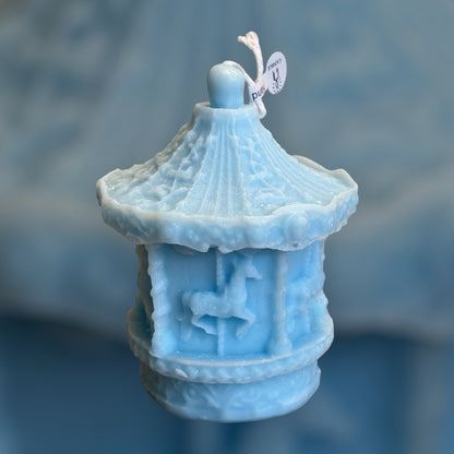 Blue car ousel candle favor for a a baby' s first birthday celebration 