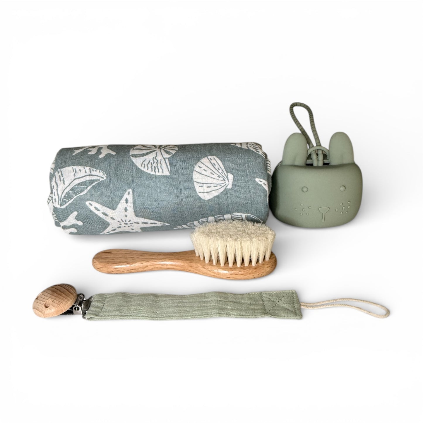 baby care essentials including a soft muslin cloth, baby brush, pacifier clip and silicone pacifier holder