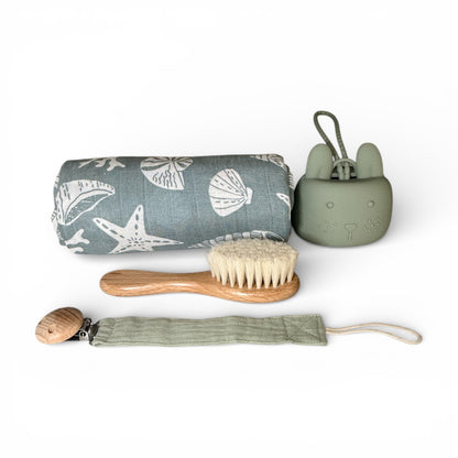 baby care essentials including a soft muslin cloth, baby brush, pacifier clip and silicone pacifier holder