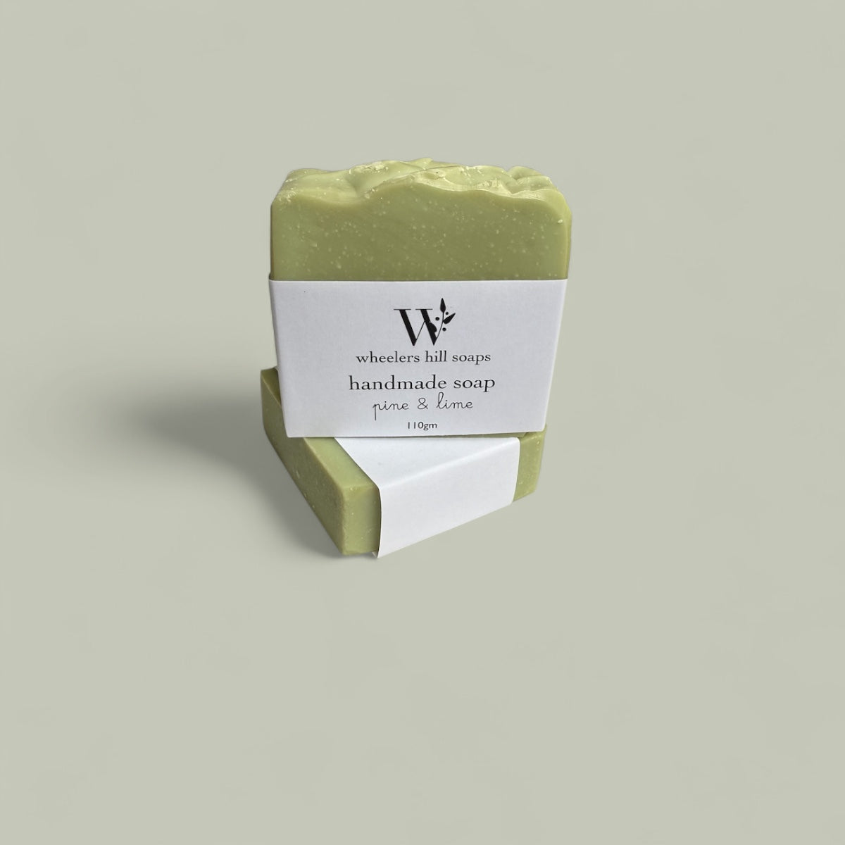 Handmade pine and lime artisan soap bar on a neutral background