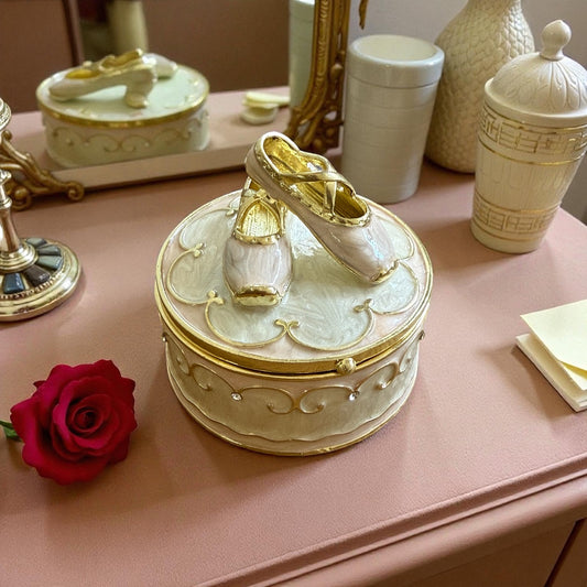 Vintage ballerina jewellery box with ballet shoes lid and gold accents displayed on a vanity surface