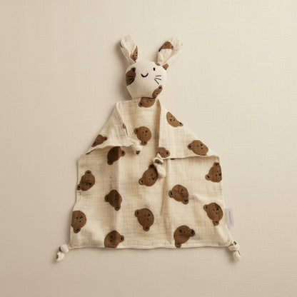 Beige bunny comfort blanket with bunny head brown teddy bear print, made from soft muslin fabric, laid flat on a white background