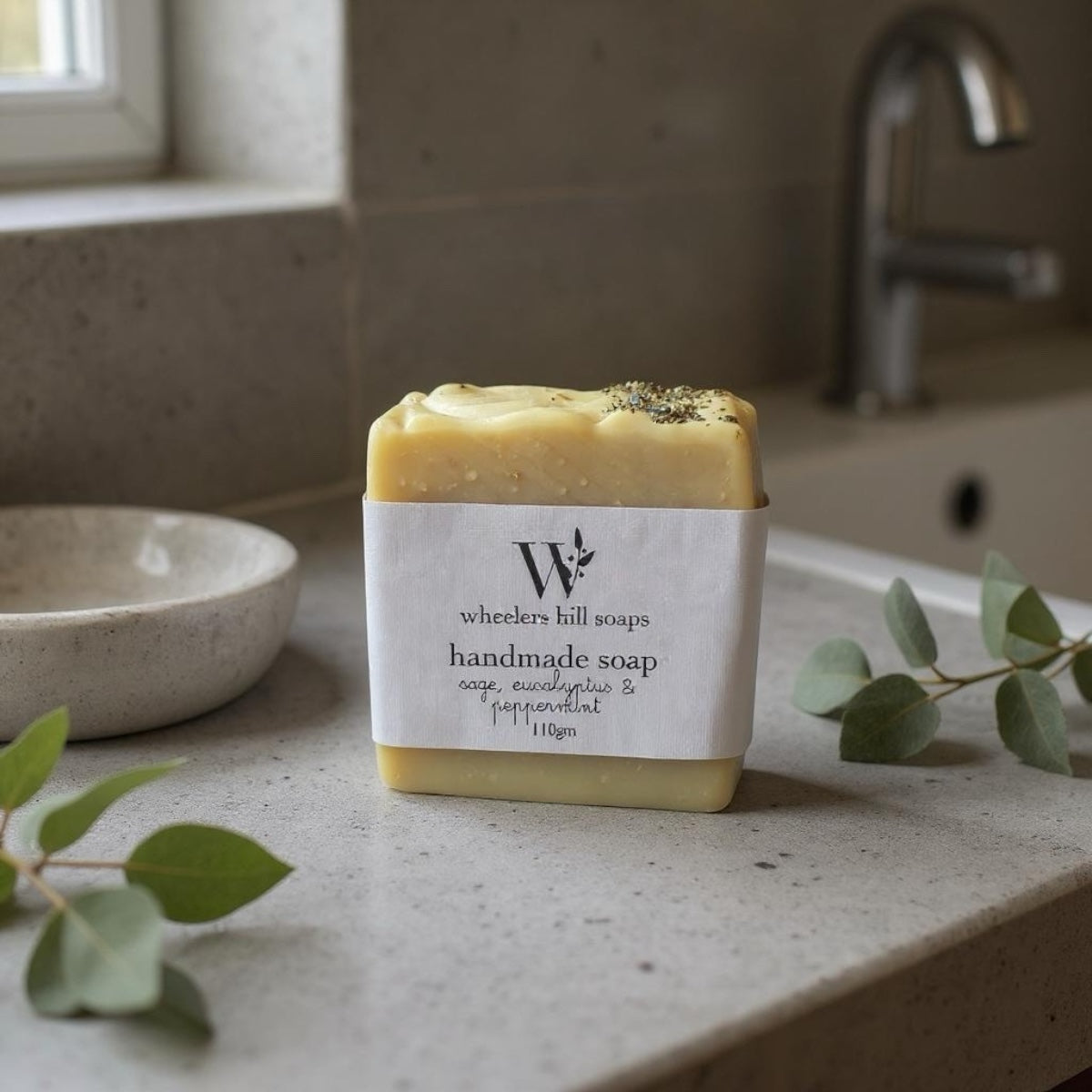Handmade artisan soap bar on a bathroom counter with natural botanicals