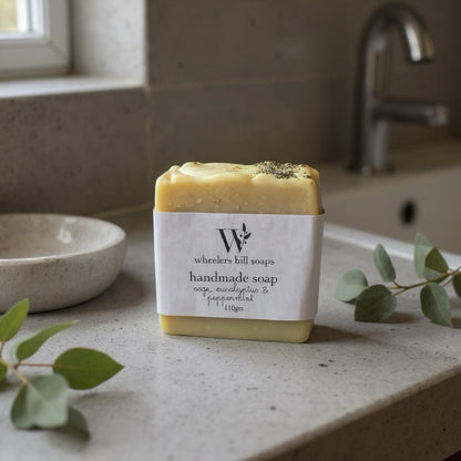Handmade artisan soap bar on a bathroom counter with natural botanicals