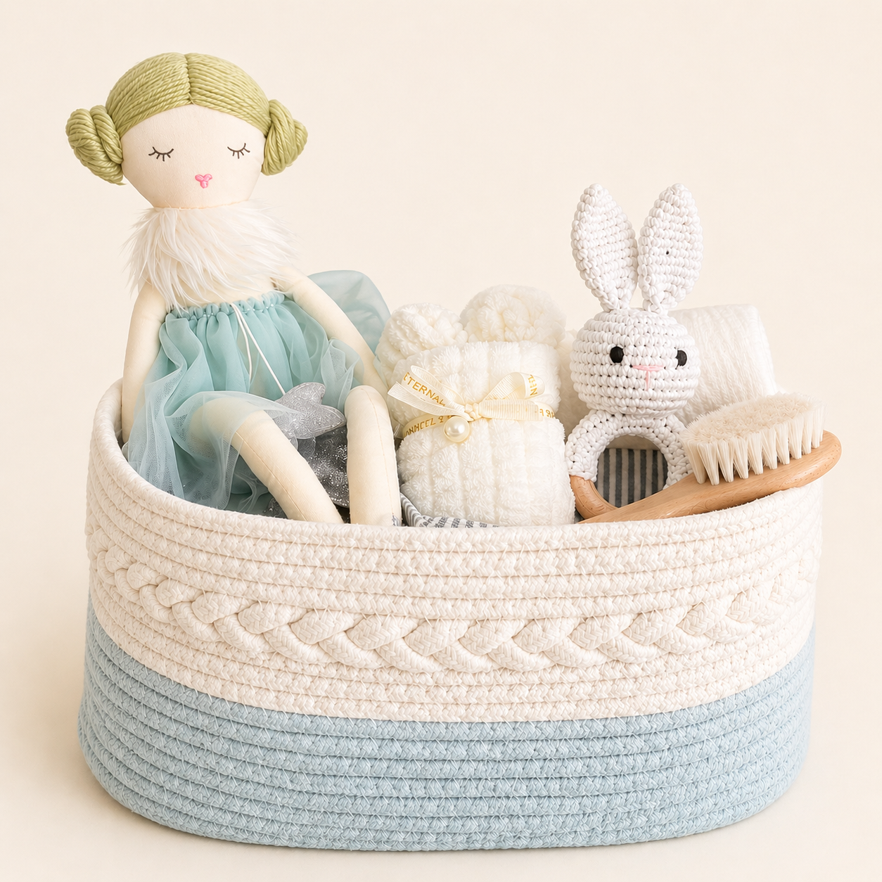 Luxury baby gift hamper in acqua tones with woven basquet, soft doll, bunny mini towel and baby essentials.