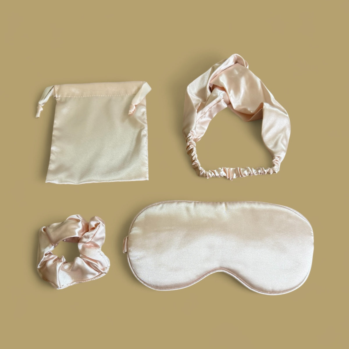 Blush pink silk sleep set with sleep mask, headband, scrunchie and pouch.