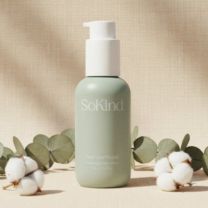 SoKind Tiny Softness hydrating baby lotion bottle in soft age green with white pump, displayed on a clean white background